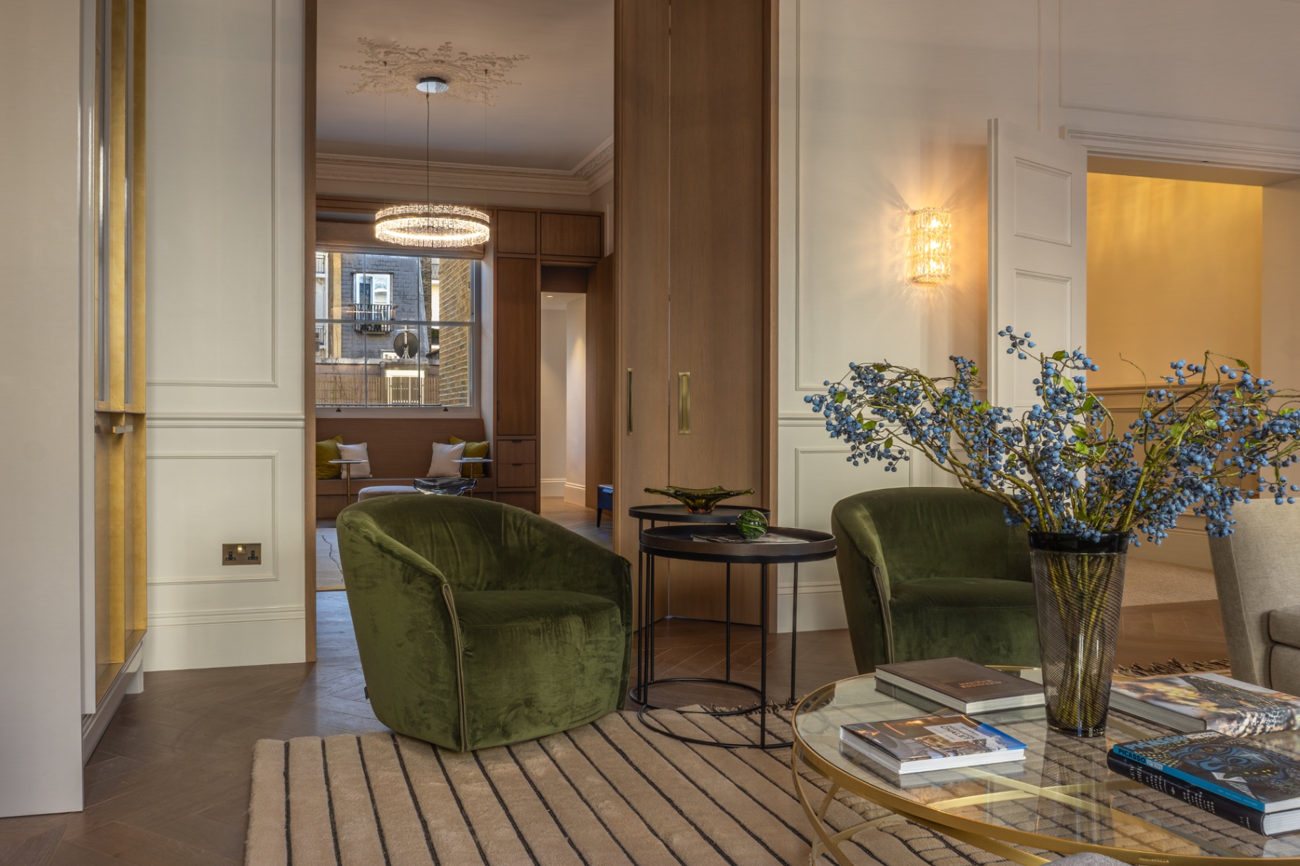 Reception room with velvet armchairs and oak pocket doors
