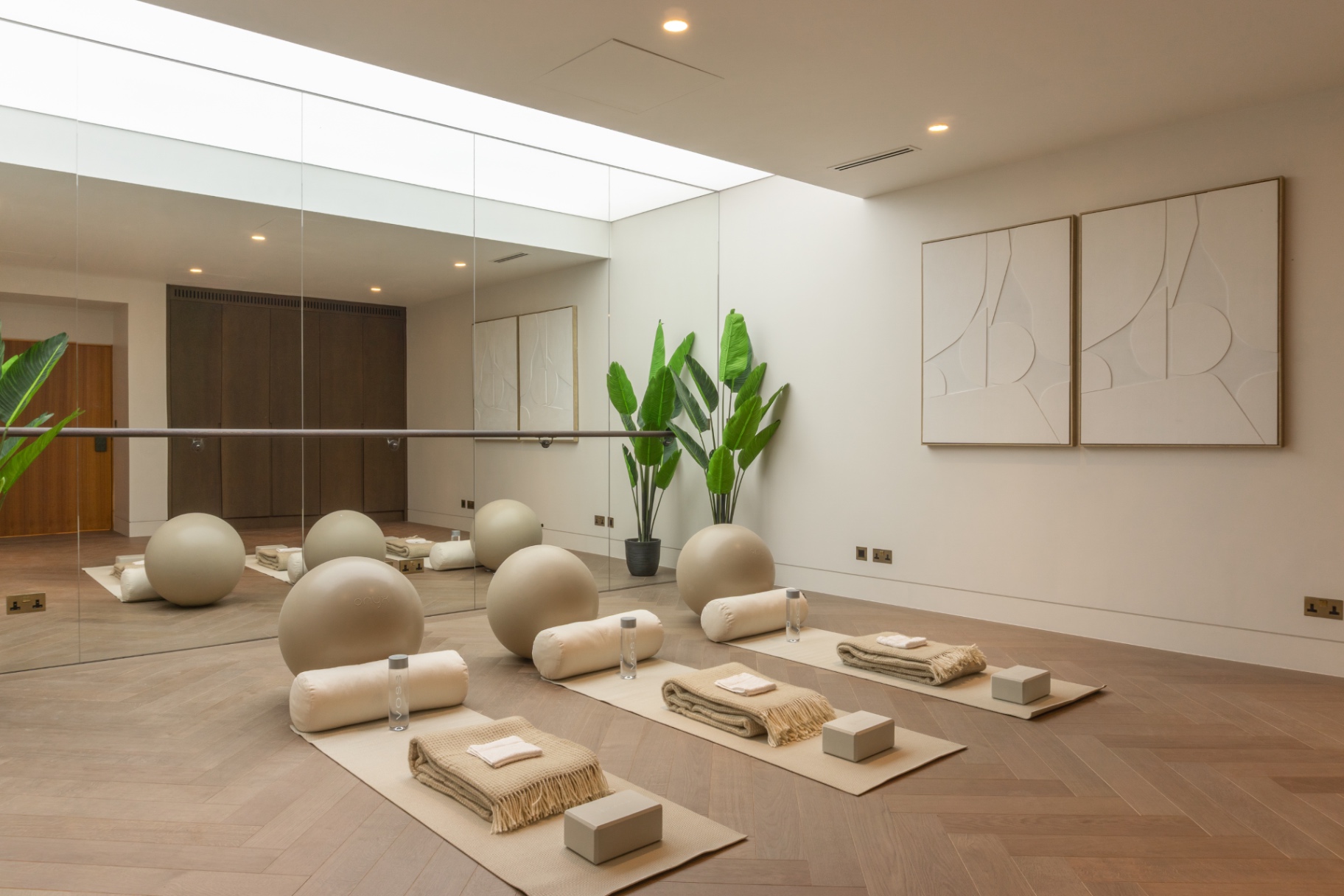 Home studio with mirrored wall and herringbone floor