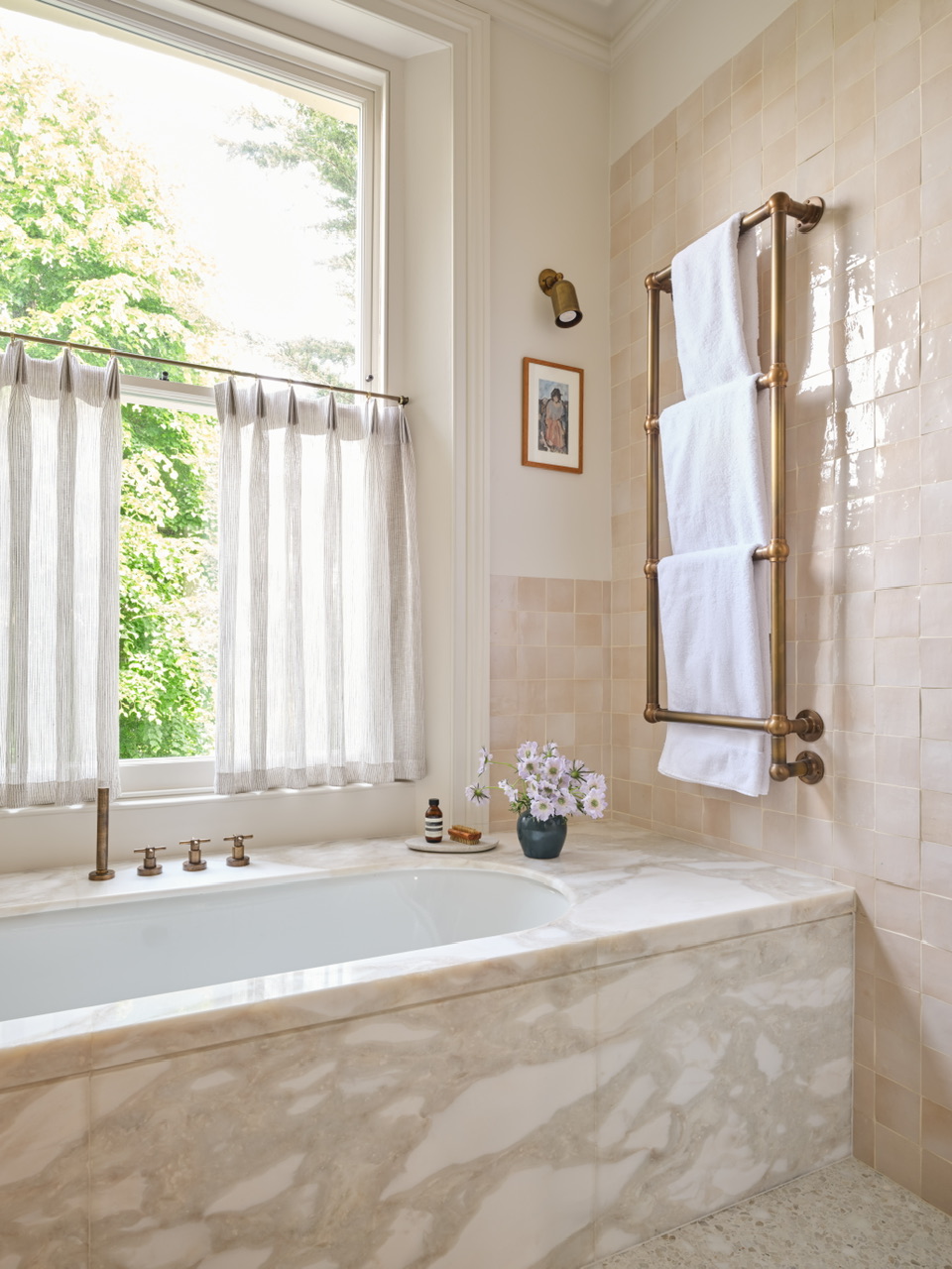 Bath with marble surround and heated towel rail