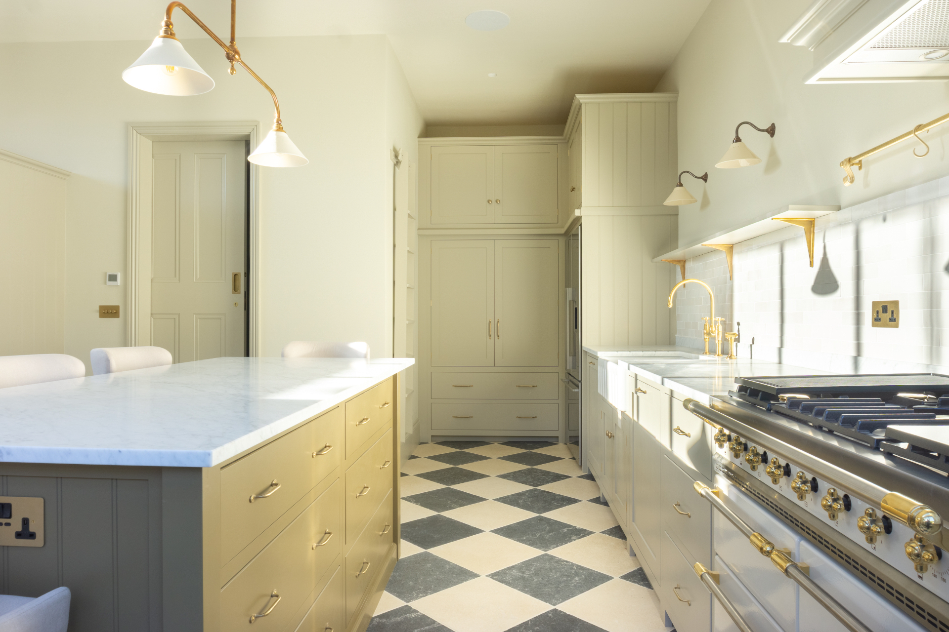 Bespoke kitchen with painted cabinetry, marble worktops and brass fittings